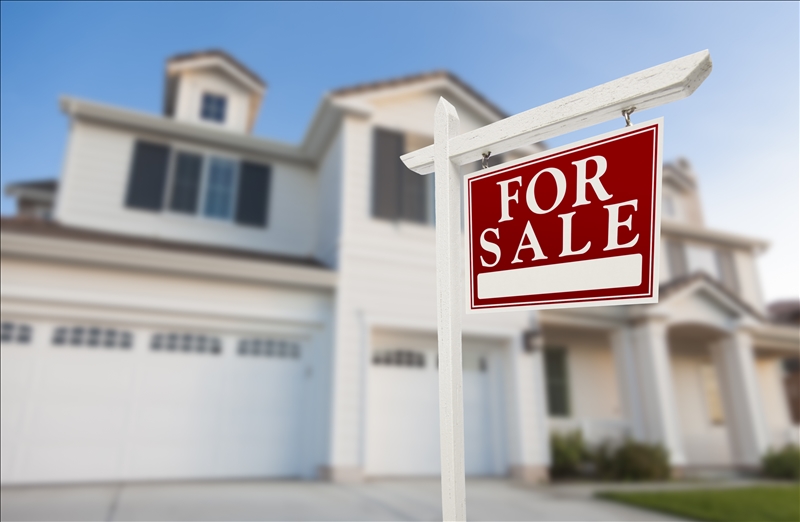 Home For Sale Real Estate Sign in Front of Beautiful New House.