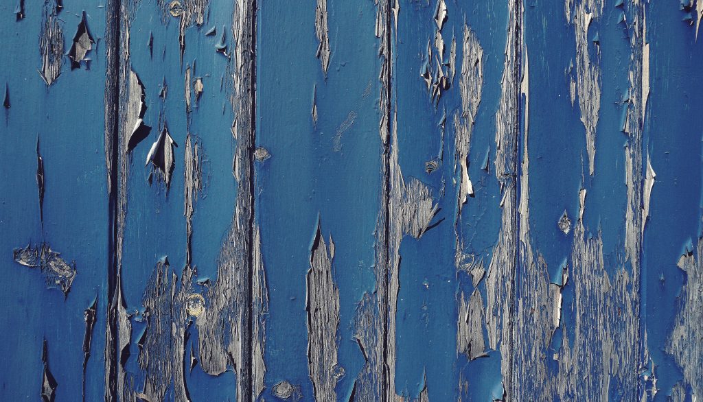 photo of decaying wood with peeling blue paint